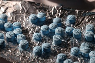 A pill press producing blue pills in Reuters' office in New York City