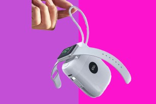 A white device with a wristband attached to it