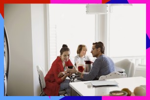 Family at table looking at cellphone