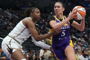 Dearica Hamby, who scored 21 points, drives on Kennedy Burke during the Liberty's 94-88 loss to the Sparks on Aug. 28, 2024.