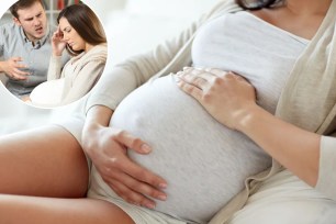 A pregnant woman holding her belly