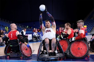 A group of men, including Mason Symons, playing wheelchair rugby